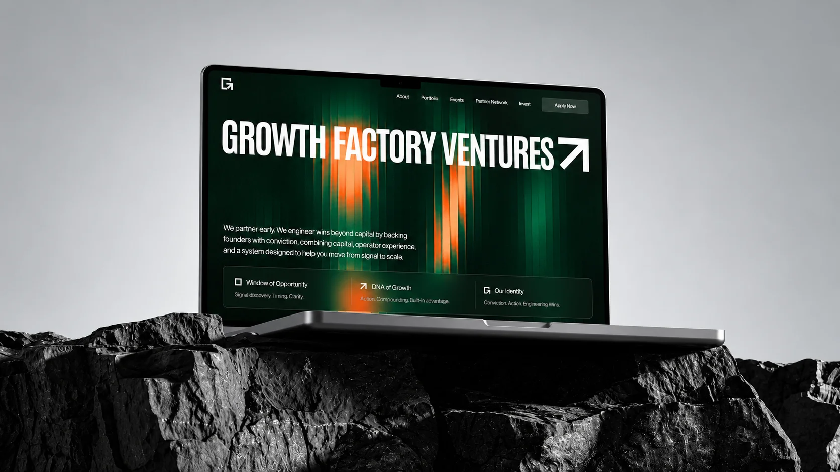 Growth Factory Ventures website displayed on a laptop above a rocky landscape.