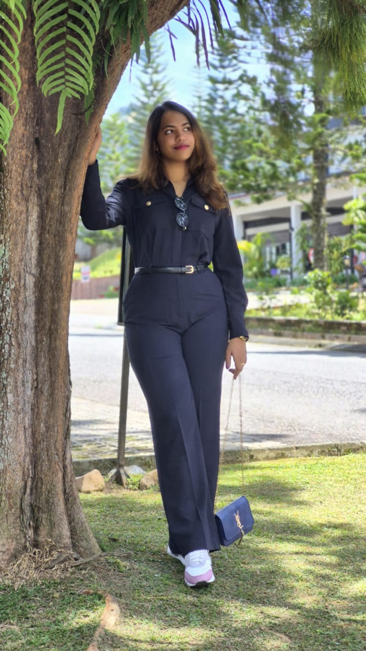 Vansita standing beneath a tree